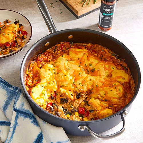 SOUTHWESTERN CHICKEN AND DUMPLINGS in a weeknight skillet from pampered chef on a table with a plate next to it