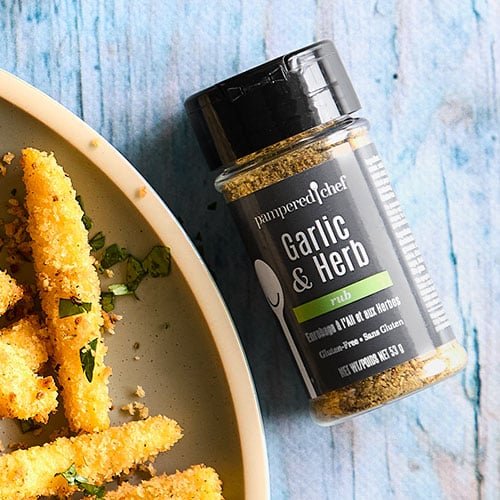 A jar of Pampered Chef Gluten-Free Garlic & Herb Seasoning, showcasing a blend of herbs and spices perfect for enhancing the flavor of various dishes.