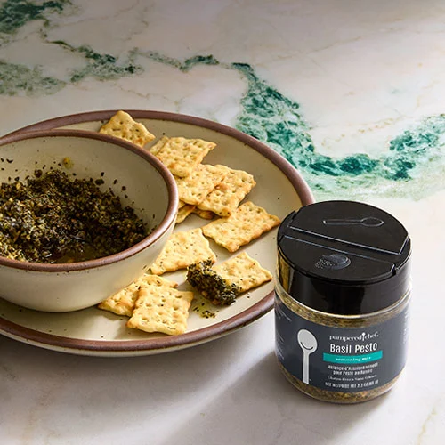 A jar of Pampered Chef Gluten-Free Bell Pepper Herb Seasoning, showcasing a blend of herbs and spices perfect for enhancing the flavor of various dishes.