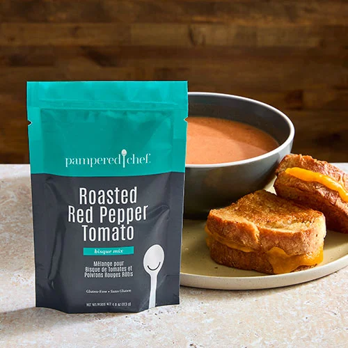 Roasted Red Pepper Tomato Soup Mix from Pampered Chef beside a bowl of tomato soup - gluten-free soup mix.