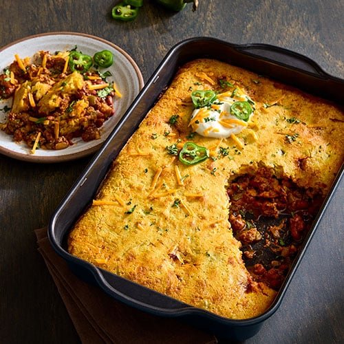 Hearty gluten-free chili and cornbread bake in a casserole dish, a perfect comfort food meal.