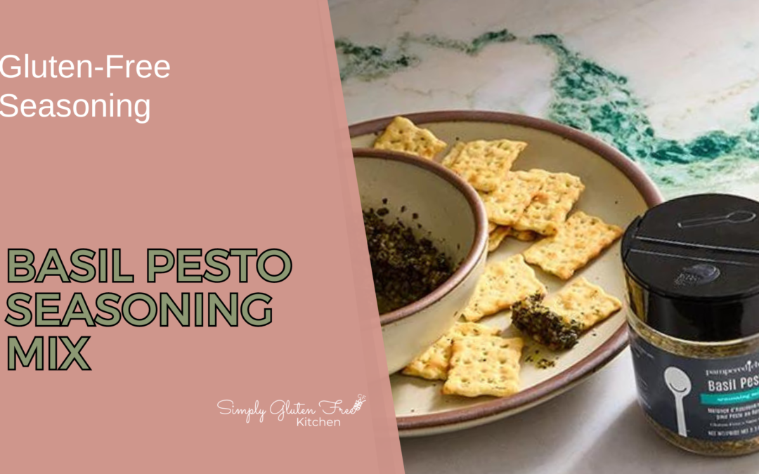 A bowl of basil pesto seasoning mix on a plate with several gluten-free crackers. A jar of Pampered Chef Basil Pesto Seasoning Mix is placed next to the plate, showcasing the product in an inviting and appetizing setting.