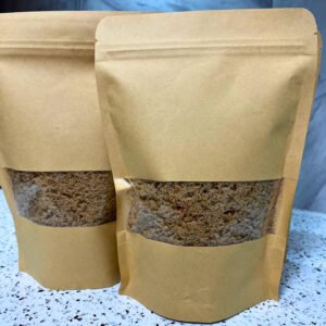 Two kraft paper bags filled with gluten-free sourdough bread crumbs, with a clear window to show the texture inside.