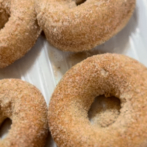 Gluten-free apple cider donuts with cinnamon sugar, baked fresh in Bay City.